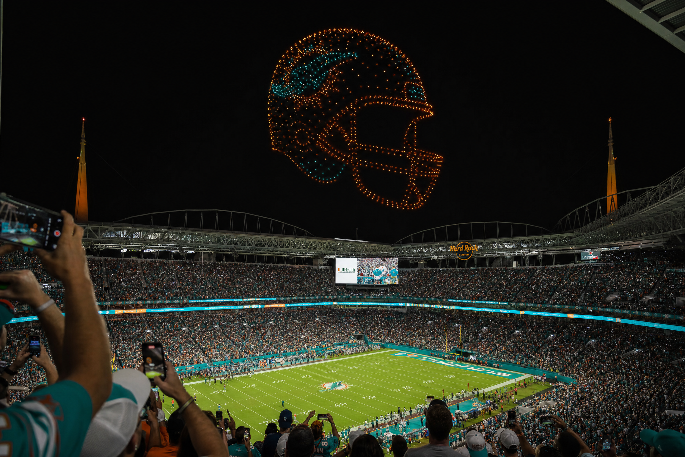NFL stadium drone show with football helmet formation