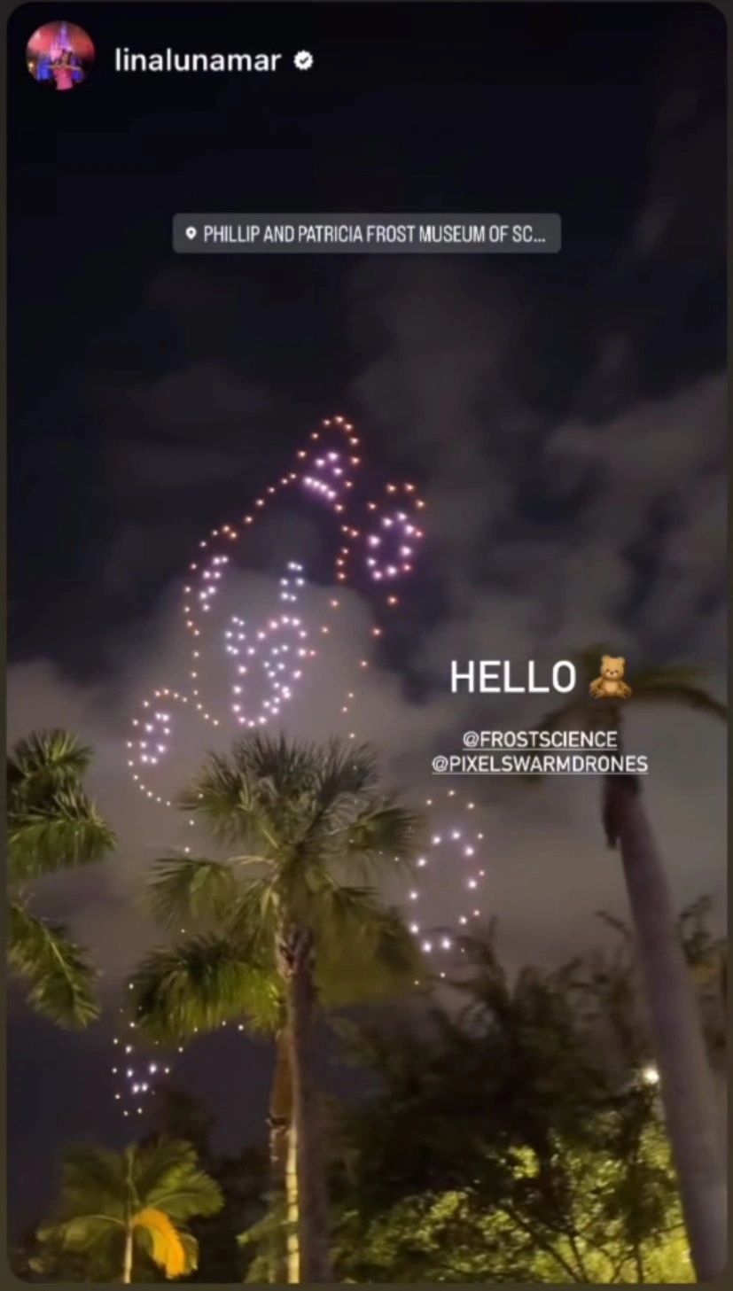 Infinity symbol drone formation over Biscayne Bay at night